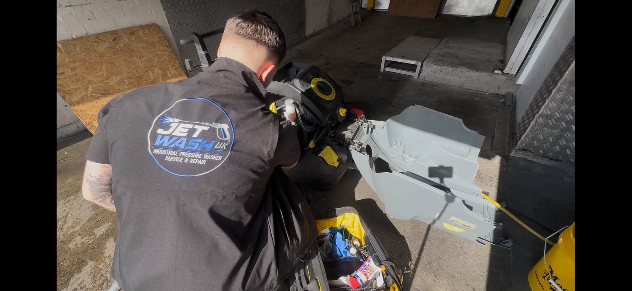 Technician servicing a pressure washer pump